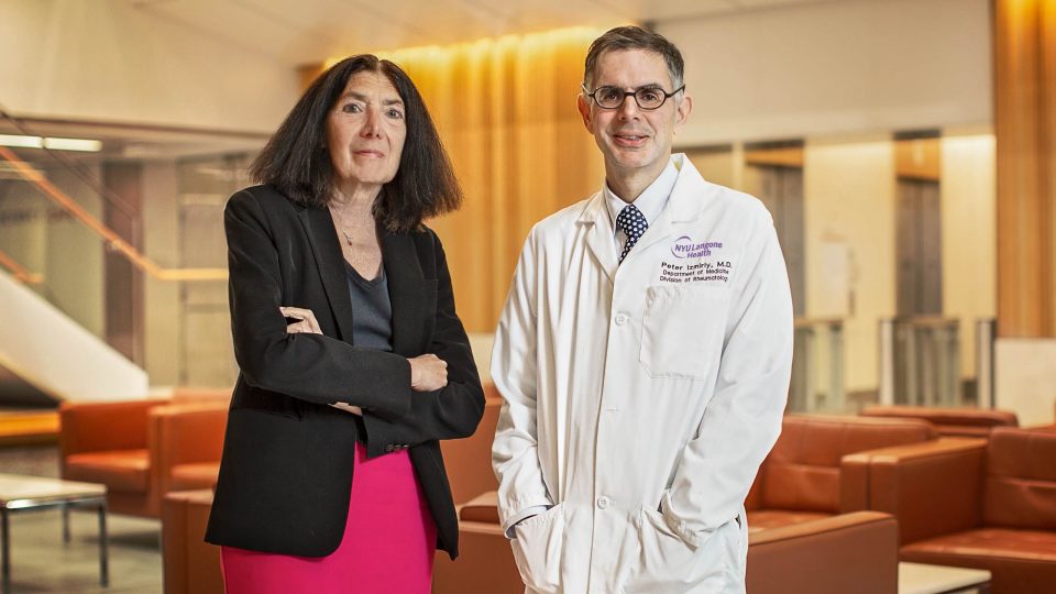 Dr. Jill P. Buyon and Dr. Peter M. Izmirly standing together in empty sitting area