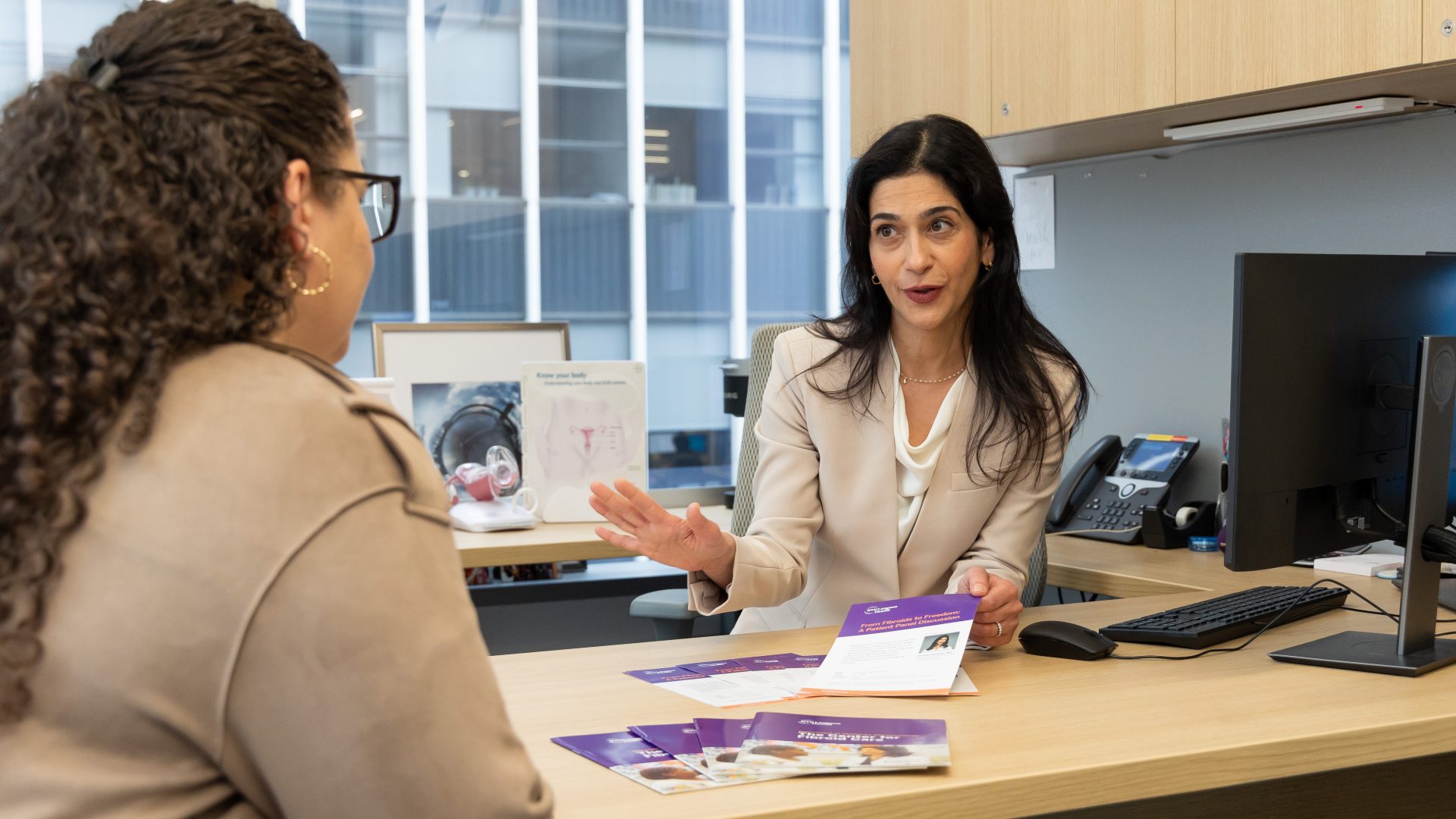 Dr. Taraneh Shirazian reviewing written materials with patient in office